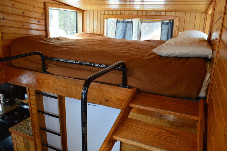 Loft bed in orange caboose in Izaak Walton - Cabin Rentals in Glacier