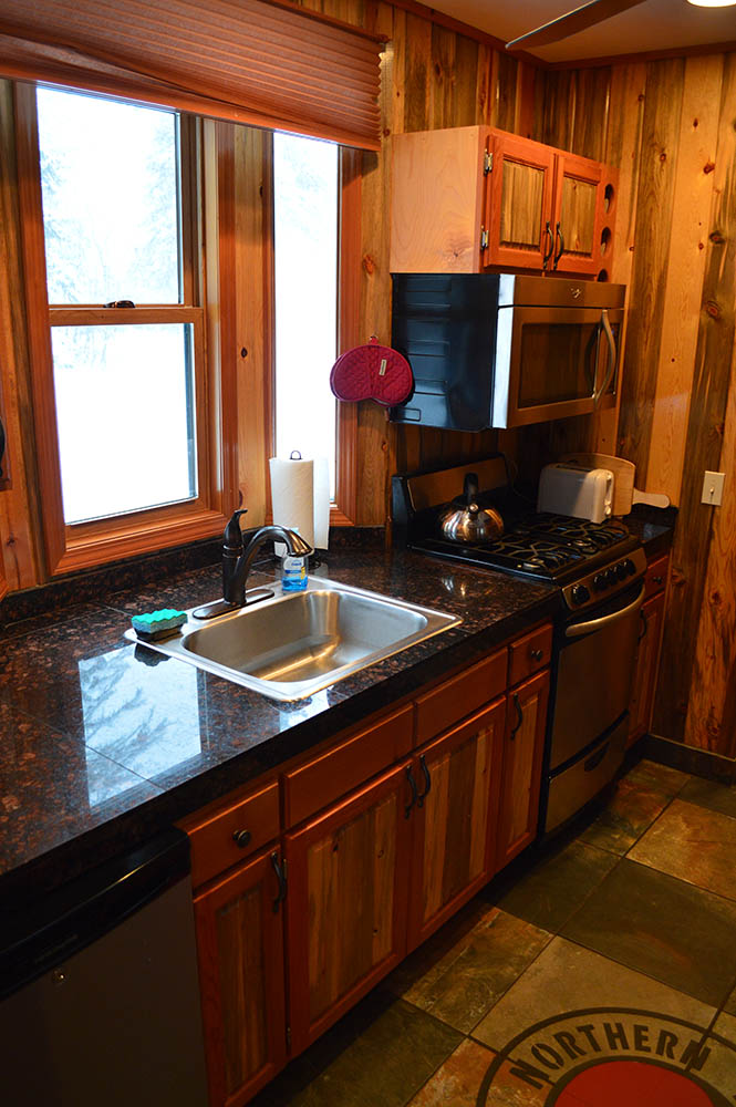 Kitchen in northern caboose located at Izaak Walton Inn - Luxury Cabins Near Glacier National Park