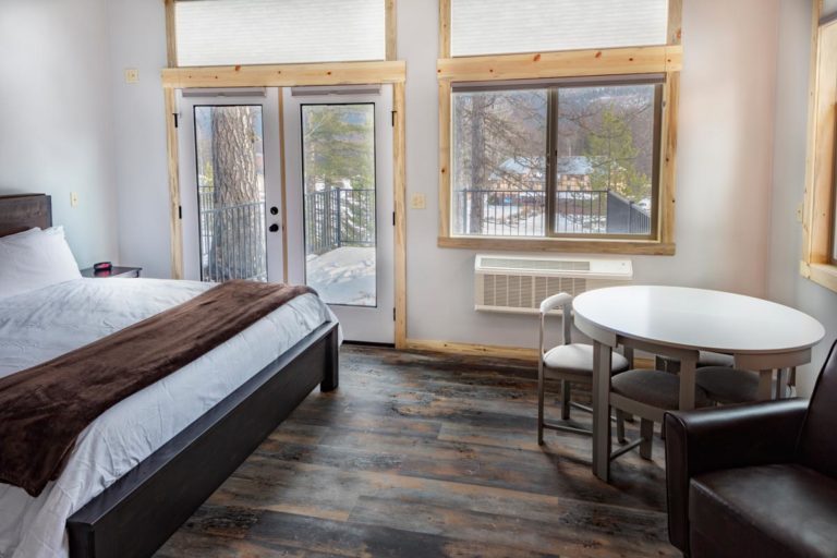 King bed in school house at Izaak Walton Inn - Cabin Rentals in Glacier