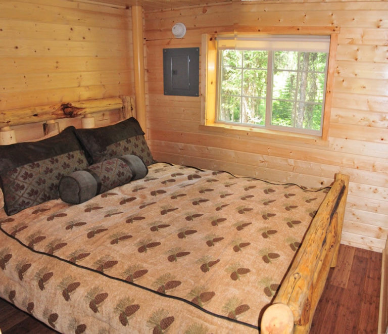 Queen bed in family cabin at Izaak Walton Inn - Cabin Rentals near Glacier National Park