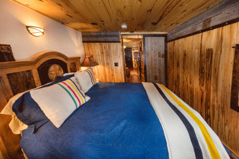 Queen bed in JJ Caboose at Izaak Walton Inn - Luxury Cabins Near Glacier National Park